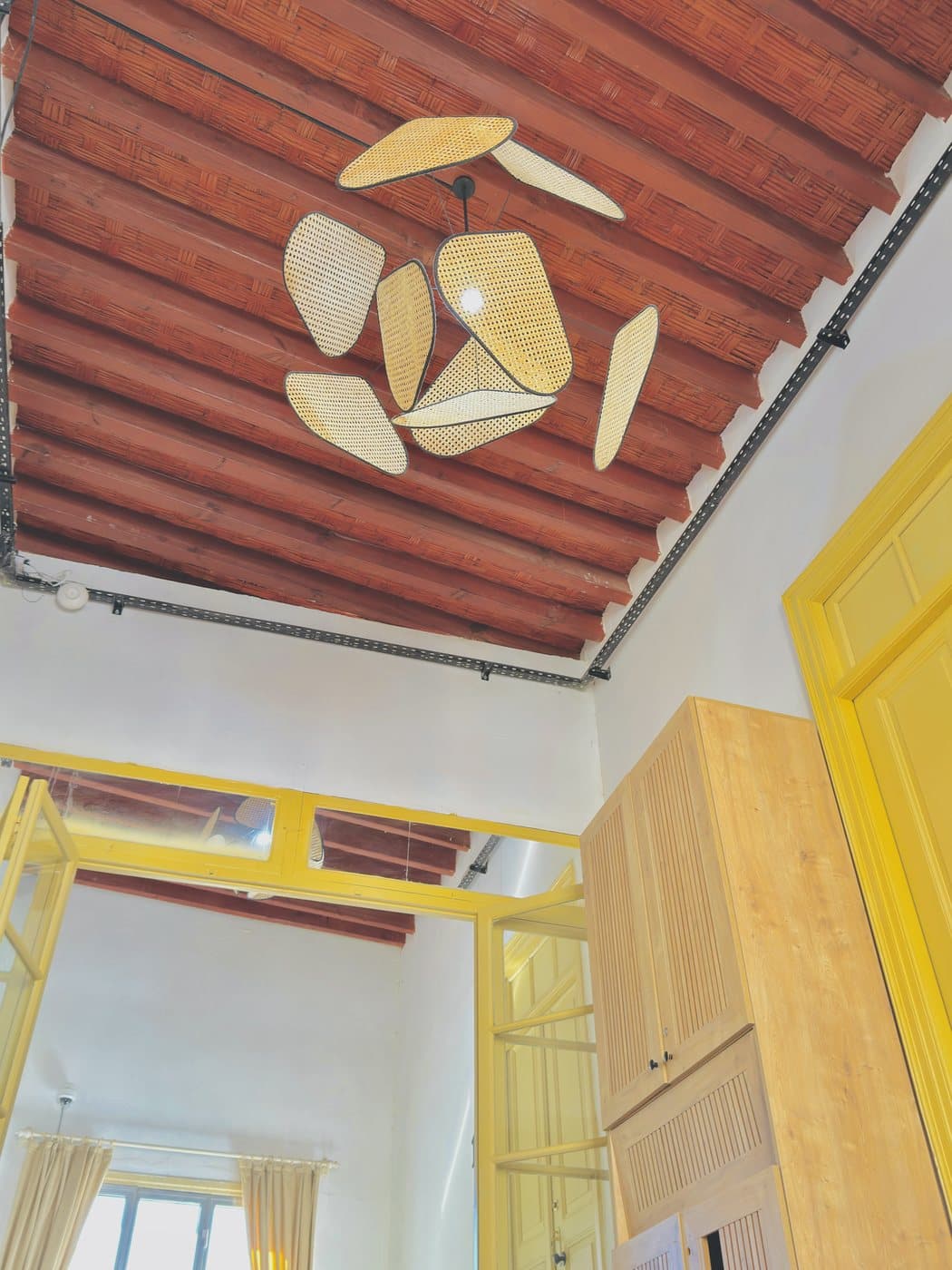 Rattan light and timber ceiling detail at Avenue Hotel